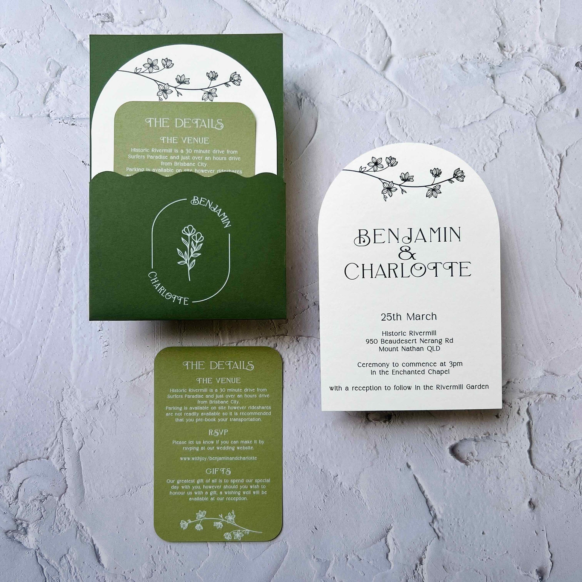 Green and white wedding invitation set on a textured gray background