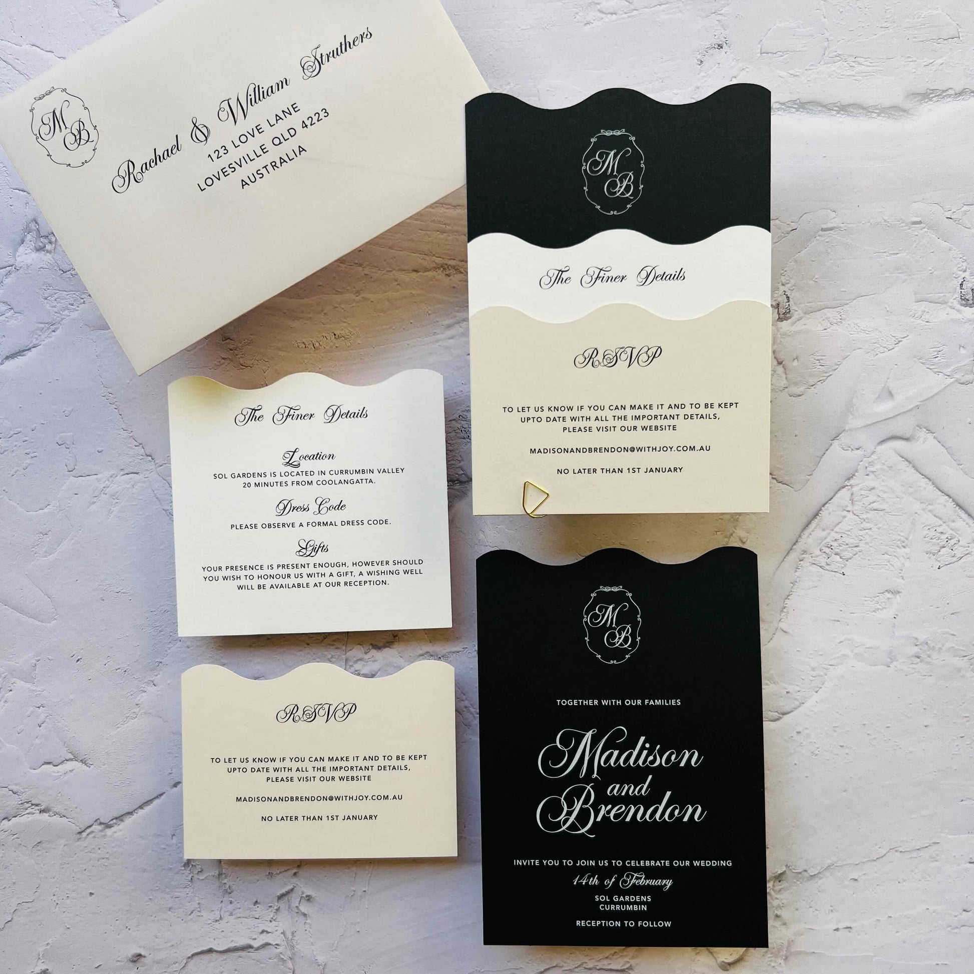 Wedding invitation set with black and white design on a textured surface