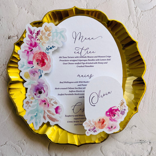 Gold-rimmed plate with floral design printed wedding menu and place card