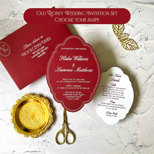 Red wedding invitation set with gold accents on a textured white background