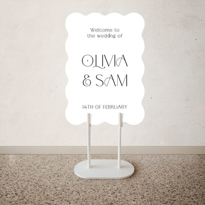 Wave Shape Wedding Welcome Sign White wedding sign with 'Welcome to the wedding of Olivia & Sam' text on a neutral background