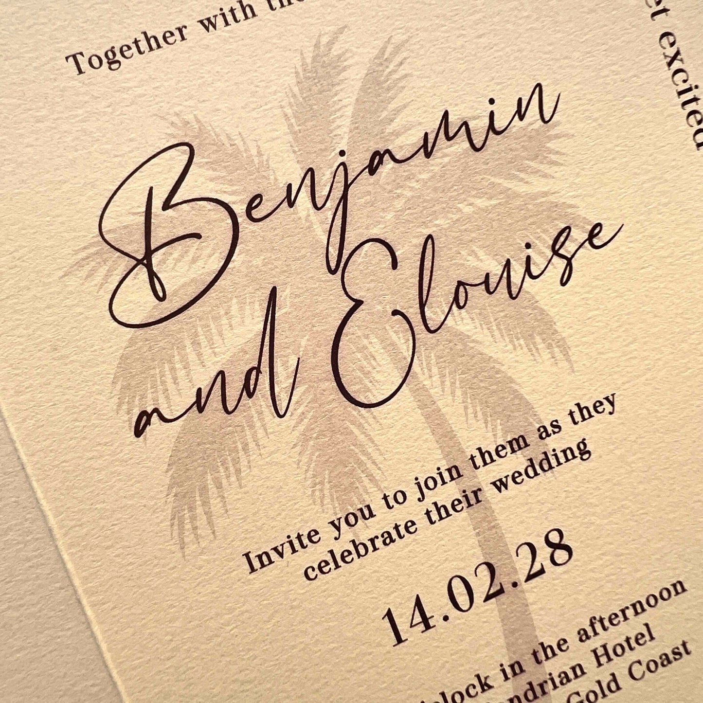 Wedding invitation with palm tree design and text on a beige background