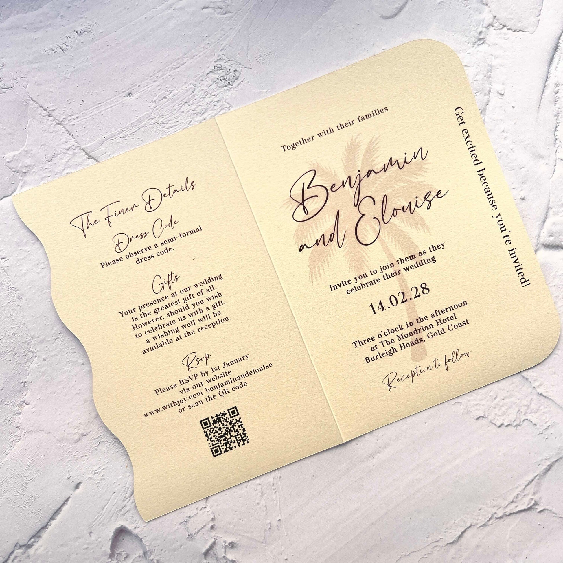 Wedding invitation card with text and QR code on a textured surface