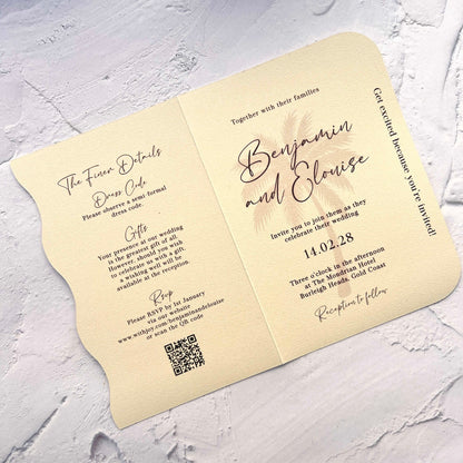 Wedding invitation card with text and QR code on a textured surface
