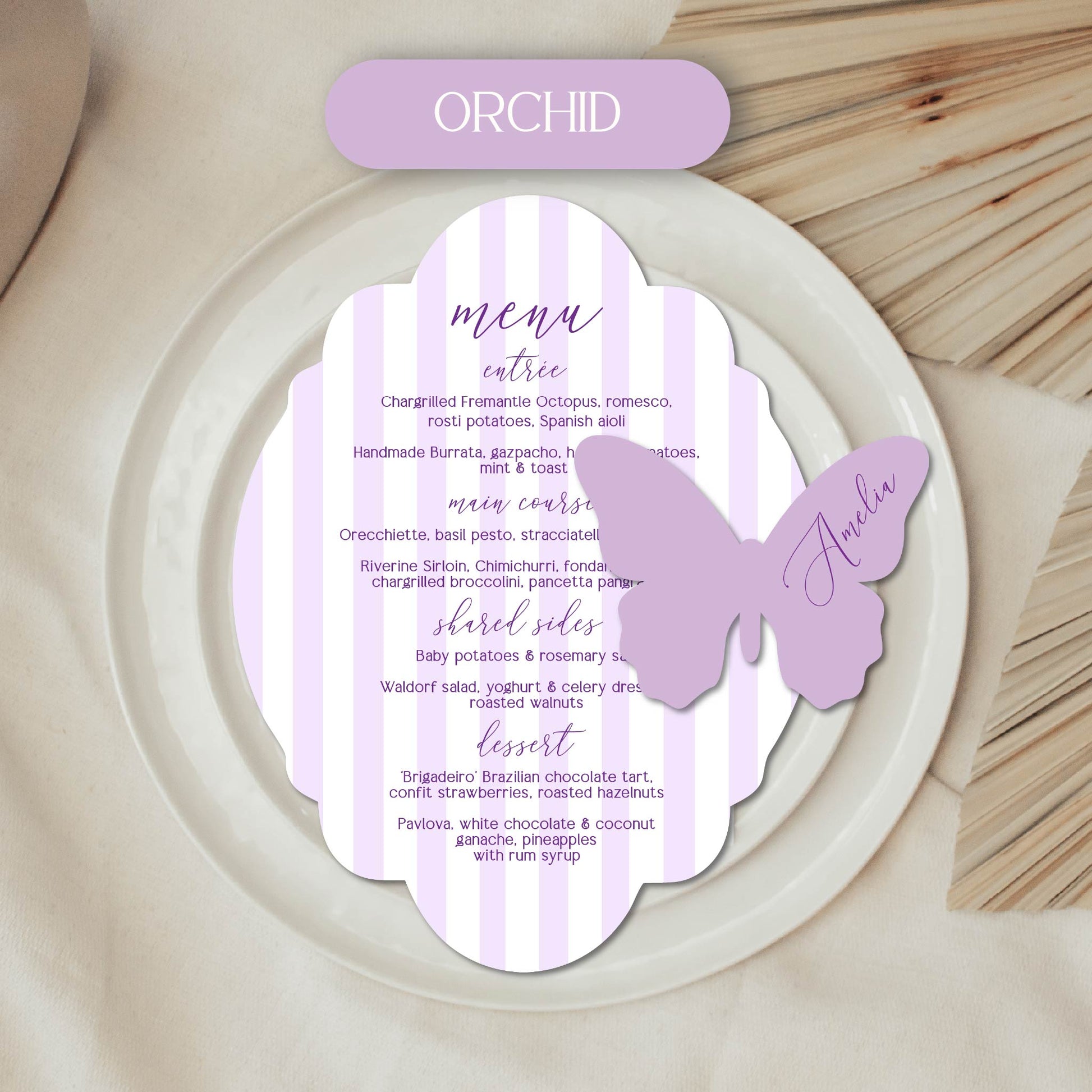 Butterfly-shaped menu card with orchid theme on a wooden surface