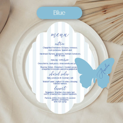Butterfly-shaped menu card with blue accents on a wooden surface